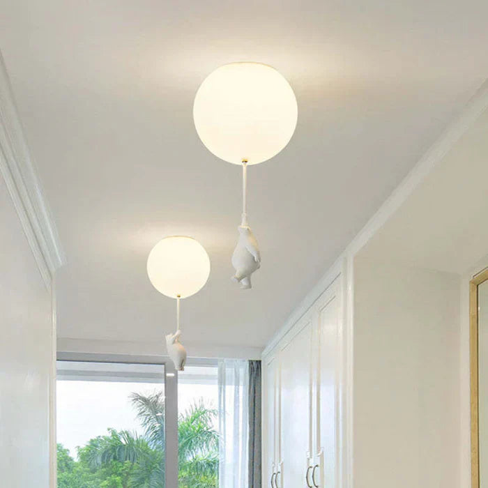 Bear and balloon pendant light with frosted glass shade in a home setting