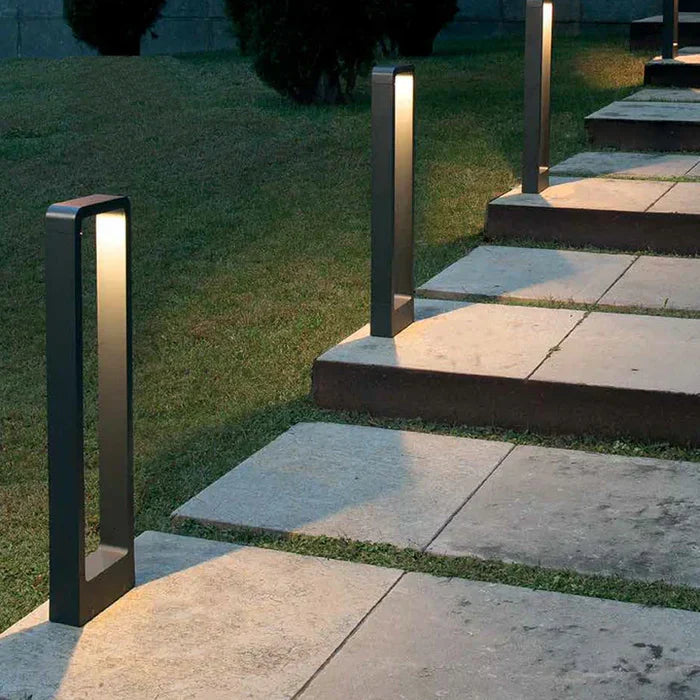 Weatherproof outdoor LED bollard light in a garden setting