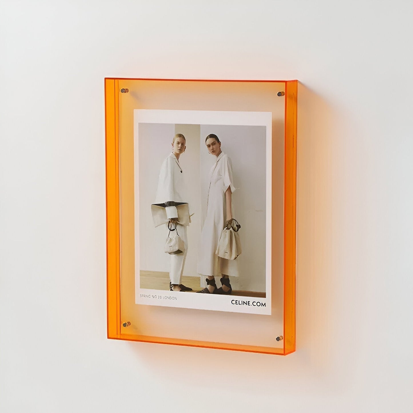 Clear acrylic floating picture frame shown in use